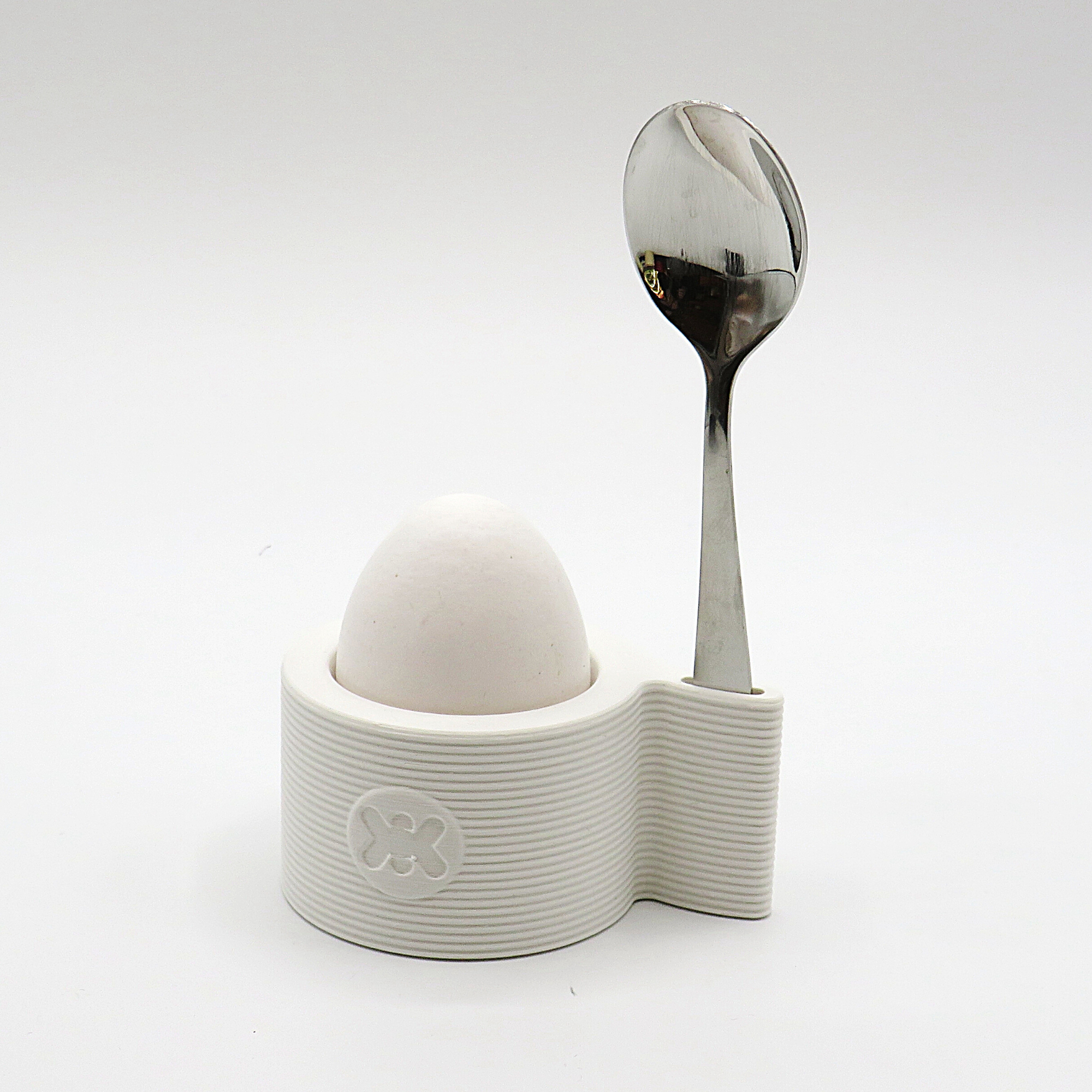 Egg cup with spoon shelf